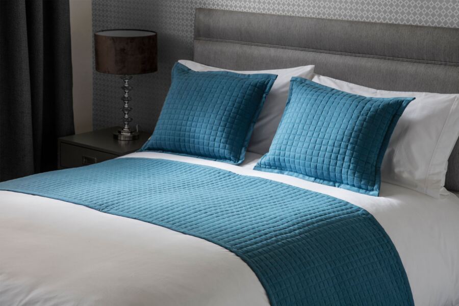teal bed runner and cushions